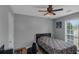 This bedroom has a ceiling fan, window, and dark bedframe at 147 Midland Dr, Stockbridge, GA 30281