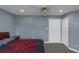 Comfortable bedroom featuring neutral gray walls, carpet, and an attractive ceiling fan with lighting at 147 Midland Dr, Stockbridge, GA 30281