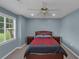 This bedroom is equipped with a ceiling fan and a dresser at 147 Midland Dr, Stockbridge, GA 30281