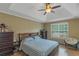 Spacious bedroom featuring tray ceilings, hardwood floors, and a large window at 147 Midland Dr, Stockbridge, GA 30281