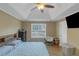 Inviting bedroom showcasing a tray ceiling, hardwood floors, and ample natural light at 147 Midland Dr, Stockbridge, GA 30281