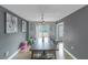 Dining room with a long table, gray walls, and sliding glass door to the backyard at 147 Midland Dr, Stockbridge, GA 30281