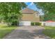 Home exterior featuring a long driveway leading to a two-car garage and well-maintained landscaping at 147 Midland Dr, Stockbridge, GA 30281