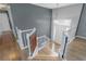 Bright foyer with hardwood floors, white staircase, and a view of the front door at 147 Midland Dr, Stockbridge, GA 30281