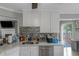 Bright kitchen showcasing white cabinets, stainless steel appliances, and a view to the backyard deck at 147 Midland Dr, Stockbridge, GA 30281