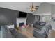 Open concept living room featuring vaulted ceiling, fireplace, ceiling fan, and wood-look flooring at 147 Midland Dr, Stockbridge, GA 30281