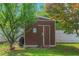 Outdoor storage shed providing ample space for gardening tools and equipment, set amongst trees at 147 Midland Dr, Stockbridge, GA 30281