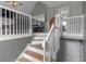 Bright staircase features wood treads, white risers, and white painted handrail at 147 Midland Dr, Stockbridge, GA 30281