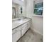 Bathroom features white vanity with granite counters and gray floors at 1710 Fontaine Dr, Jonesboro, GA 30236