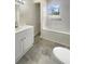 A renovated bathroom with gray tile, white cabinets, and a shower-tub combination at 1710 Fontaine Dr, Jonesboro, GA 30236