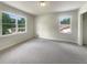 Bright bedroom featuring neutral paint, two windows providing natural light, and new carpet at 1710 Fontaine Dr, Jonesboro, GA 30236