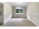 Empty dining room with carpet, white walls and large window to let in natural light at 1710 Fontaine Dr, Jonesboro, GA 30236