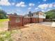 View of the back of the home, showing the brick walls and white siding at 1710 Fontaine Dr, Jonesboro, GA 30236