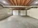 Unfinished two-car garage with concrete floor, block walls, exposed wood ceiling at 1710 Fontaine Dr, Jonesboro, GA 30236
