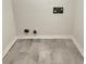 A laundry room with updated gray tile flooring and neutral-colored walls at 1710 Fontaine Dr, Jonesboro, GA 30236