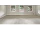 Spacious room with carpet and beautiful arched windows providing natural light and scenic views at 1710 Fontaine Dr, Jonesboro, GA 30236