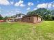 Landscaped yard with grass and a red brick wall at 1710 Fontaine Dr, Jonesboro, GA 30236