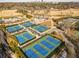 Aerial view of tennis courts and distant city skyline with lush trees and well kept parking area at 1764 Defoor Nw Ave, Atlanta, GA 30318