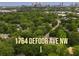 Aerial view of property and surrounding neighborhood with a view of the city skyline at 1764 Defoor Nw Ave, Atlanta, GA 30318
