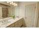 Elegant bathroom featuring a double vanity, a large mirror, and stylish lighting fixtures at 1764 Defoor Nw Ave, Atlanta, GA 30318