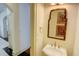 Powder room featuring decorative mirror, pedestal sink, and elegant finishes near hardwood and tile flooring at 1764 Defoor Nw Ave, Atlanta, GA 30318