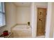 Bright bathroom with a modern tub, glass-enclosed shower, and tile flooring at 1764 Defoor Nw Ave, Atlanta, GA 30318