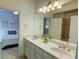 Well-lit bathroom featuring a double vanity with white countertops and a view to the bedroom at 1764 Defoor Nw Ave, Atlanta, GA 30318