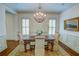 Bright dining room with a chandelier, shutters, and a decorative rug at 1764 Defoor Nw Ave, Atlanta, GA 30318