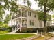 Stately two-story home boasts a charming exterior with double porches, lush landscaping, and mature shade trees at 1764 Defoor Nw Ave, Atlanta, GA 30318