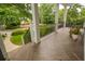 Relaxing covered front porch with herringbone-patterned floor provides a charming space to enjoy neighborhood views at 1764 Defoor Nw Ave, Atlanta, GA 30318