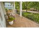 Charming covered porch with herringbone floor has ample space to unwind while enjoying neighborhood scenery at 1764 Defoor Nw Ave, Atlanta, GA 30318