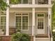 Inviting front porch features classic columns, a decorative railing, and a traditional white door with sidelights at 1764 Defoor Nw Ave, Atlanta, GA 30318