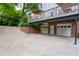 Spacious three car garage with brick siding underneath a raised wood deck at 1764 Defoor Nw Ave, Atlanta, GA 30318