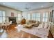 Cozy living room with fireplace, hardwood floors, and abundant natural light at 1764 Defoor Nw Ave, Atlanta, GA 30318