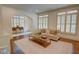 Bright living room boasts an open layout, hardwood floors, and lots of natural light through large shuttered windows at 1764 Defoor Nw Ave, Atlanta, GA 30318