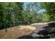 A community playground is complete with swings, playhouses, slides, and is surrounded by trees at 1764 Defoor Nw Ave, Atlanta, GA 30318