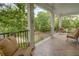 Inviting covered porch with comfortable seating, a view of the neighborhood, and a herringbone-patterned floor at 1764 Defoor Nw Ave, Atlanta, GA 30318