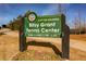 City of Atlanta Bitsy Grant Tennis Center sign shows hours with park entrance and walking bridge in background at 1764 Defoor Nw Ave, Atlanta, GA 30318