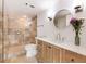 Bathroom featuring a walk-in shower, wooden vanity, and a round mirror at 2870 Pharr Court South Nw # 1405, Atlanta, GA 30305