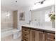 Bathroom featuring a shower over tub, rustic vanity, and marble countertop at 2870 Pharr Court South Nw # 1405, Atlanta, GA 30305