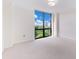 Bright bedroom with neutral carpet, white walls, and one large window with city views at 2870 Pharr Court South Nw # 1405, Atlanta, GA 30305