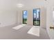 Bright bedroom with neutral carpet, white walls, and two windows with city views at 2870 Pharr Court South Nw # 1405, Atlanta, GA 30305