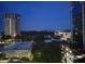 An evening view of the cityscape from a high-rise building, showcasing city lights and surrounding structures at 2870 Pharr Court South Nw # 1405, Atlanta, GA 30305