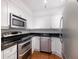 Kitchen with stainless steel appliances, white cabinetry, and granite countertop at 2870 Pharr Court South Nw # 1405, Atlanta, GA 30305