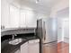 Kitchen with stainless steel appliances, white cabinetry, and granite countertop at 2870 Pharr Court South Nw # 1405, Atlanta, GA 30305