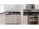 Kitchen featuring stainless steel appliances, white cabinetry, and black granite countertops at 2870 Pharr Court South Nw # 1405, Atlanta, GA 30305