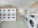 Bright laundry room features rows of efficient washers and dryers at 2870 Pharr Court South Nw # 1405, Atlanta, GA 30305