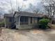 Side exterior view of home with screened porch and spacious driveway at 3143 Cedar St, Scottdale, GA 30079