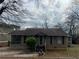 Charming single-story home with a cozy front porch and mature landscaping at 3143 Cedar St, Scottdale, GA 30079