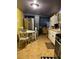 Bright kitchen with stainless steel appliances, white cabinets, and dining area at 3143 Cedar St, Scottdale, GA 30079